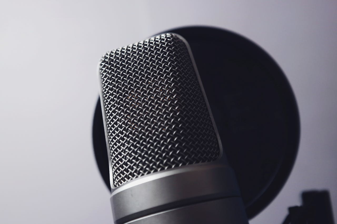 About A close-up of a professional microphone in a studio. Ideal for music and broadcasting themes.